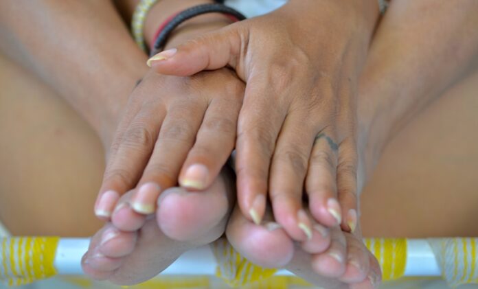 A close up of a person holding their hands together