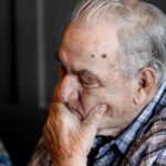 man holding chin