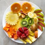 무더운 여름, 건강하게 보내는 5가지 생활수칙 a white plate topped with cut up fruit