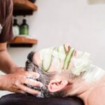 A man getting a facial mask on his face