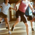 group of women running on brown wooden floor