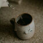 “나를 위한 작은 변화, 웰니스 문화가 일상으로 스며든다” a cup of coffee is being filled with water