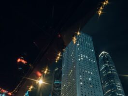 “현대인의 스트레스, 일상 속 작은 습관으로 건강하게 관리한다” Man in suit enters taxi with city skyscrapers at night