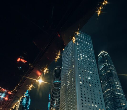 “현대인의 스트레스, 일상 속 작은 습관으로 건강하게 관리한다” Man in suit enters taxi with city skyscrapers at night