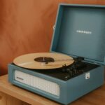 A blue record player with a record on it.