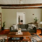 Living room with sofa, coffee table, and exposed beams