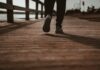 ‘걷기’로 챙기는 건강, 생활 속 스마트하게 실천하는 방법 person in black pants and black shoes standing on brown wooden dock during daytime